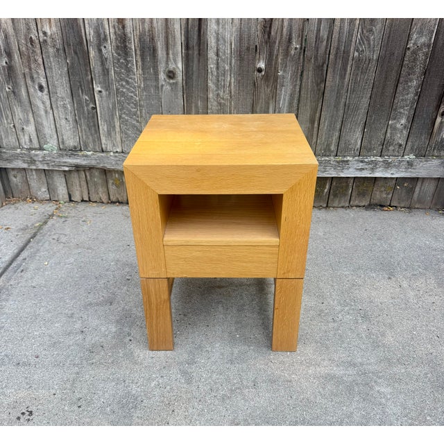 Oak side table or nightstand in a modern style reminiscent of designs by George Nelson or Pierre Chapo. One drawer on...