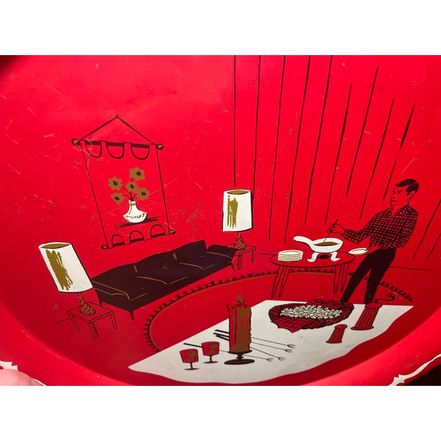 Charming vintage red metal serving tray featuring a mid-century illustrated dining room scene with warm graphic details...