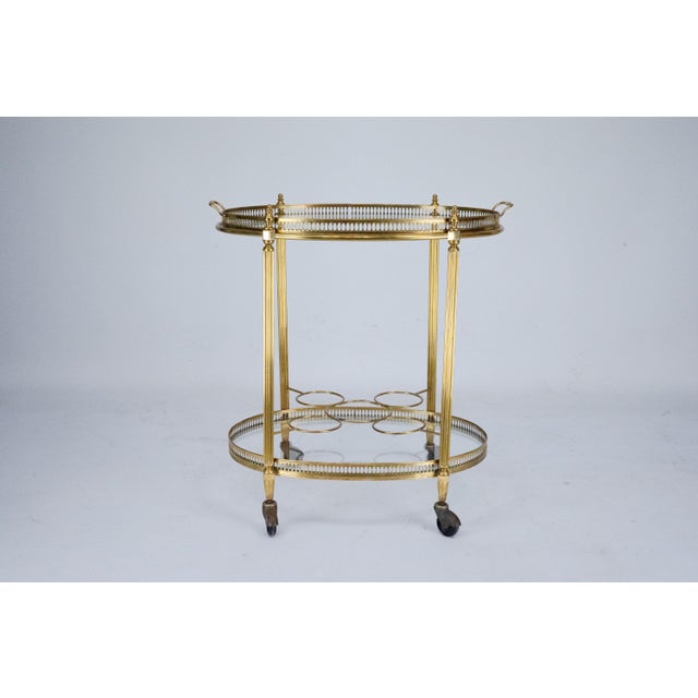 This elegant mid-century serving trolley is a refined example of Italian design from the 1950s. The piece is crafted from...