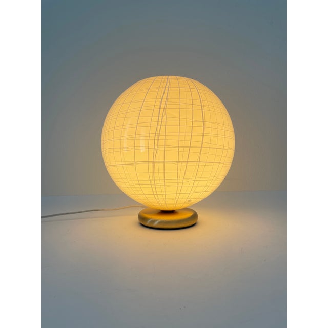Precious peonia t 25 table lamp by la murrina murano. The cased glass has a refined cream-colored base and a white...