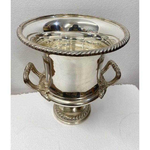 A silver-plated Regency Revival campana-form wine cooler, of elegant neoclassical design, raised on a circular reeded foot...
