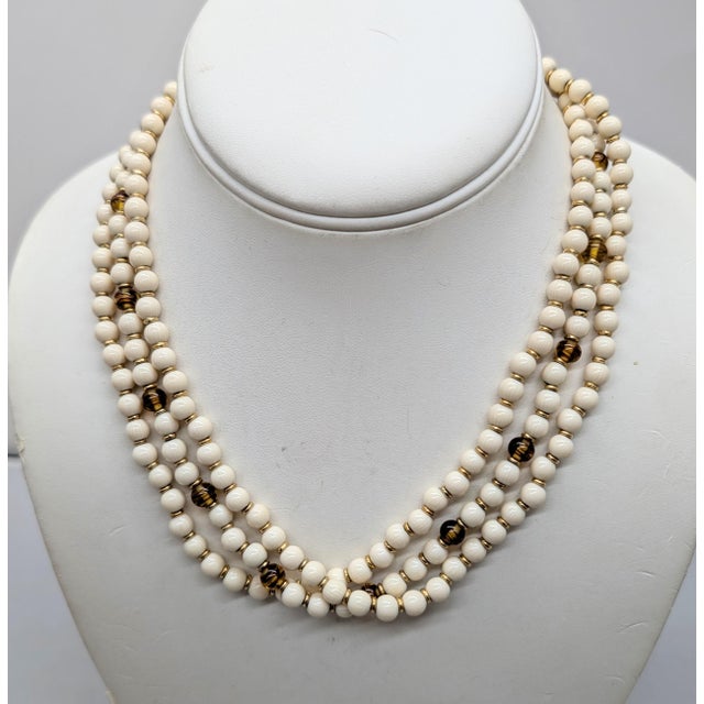 1980s goldtone spherical faux-ivory beads with faux-tiger's eye accents torsade necklace with oval cabochon faux-ivory at...