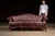 c. 1970s/1980s; Leathercraft, Inc. - Conover, NC Elegant tufted camelback sofa upholstered in oxblood red leather with...