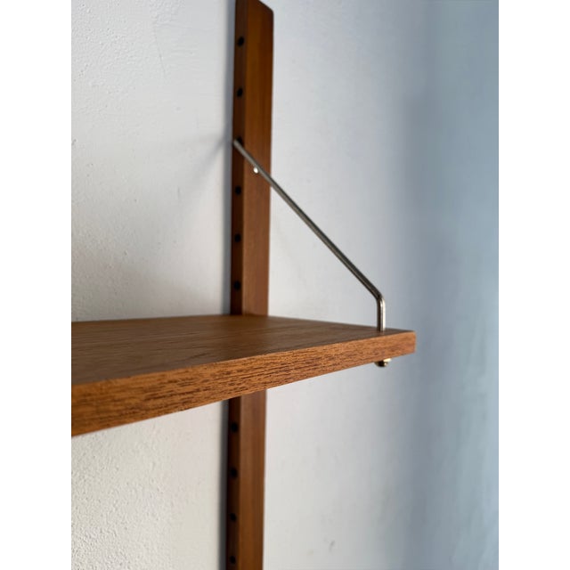An original Scandinavian modular wall system from the 1960s, crafted in teak. Its light, minimalist construction is...
