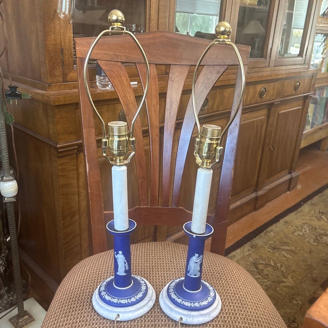 Beautiful pair of Wedgwood Neoclassical Lamps with two women figures on each lamp and a laurel leaf on the bottom. The...