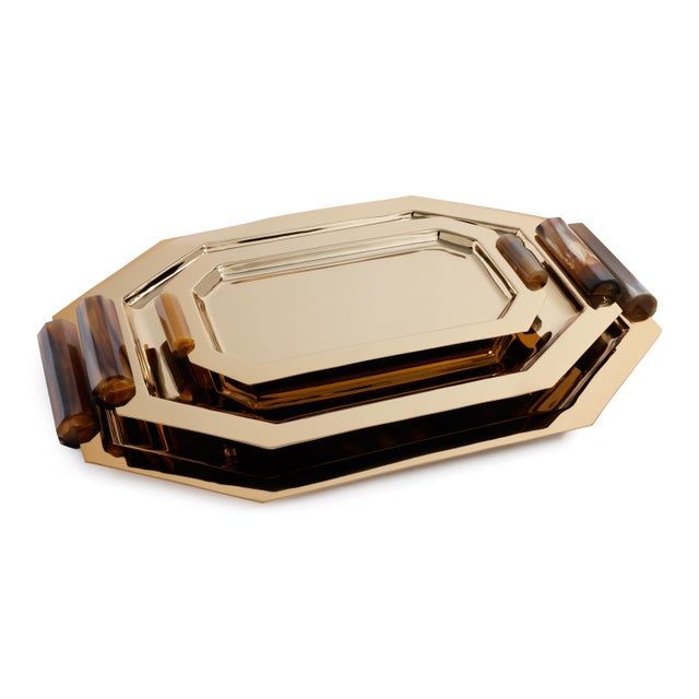 Bring a touch of elevated sophistication to your tabletop or bar with these polished metal serving trays featuring...