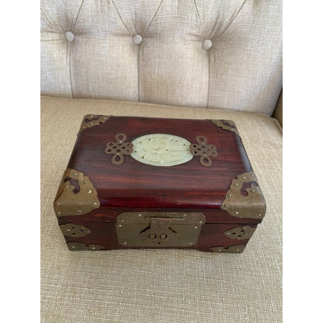 Vintage rosewood jewelry box with brass and jade detailing galore. The body of this piece is stunning - a warm medium wood...