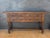 Spanish Renaissance Revival console table featuring four carved drawers and distinctive spiral turned front legs. The...