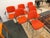 Design Plus Gallery presents a Set of Six Orange Modernist Arm Chairs from HighTower. The chairs are cloth wrapped in a...