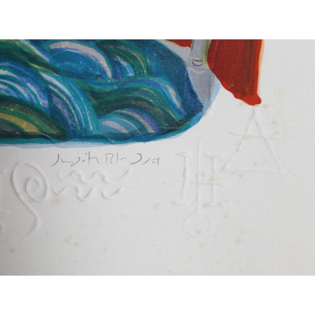 Wearing a long red cloak, the figure emodying Aquarius performs their act as the "water bearer" and empties the large...