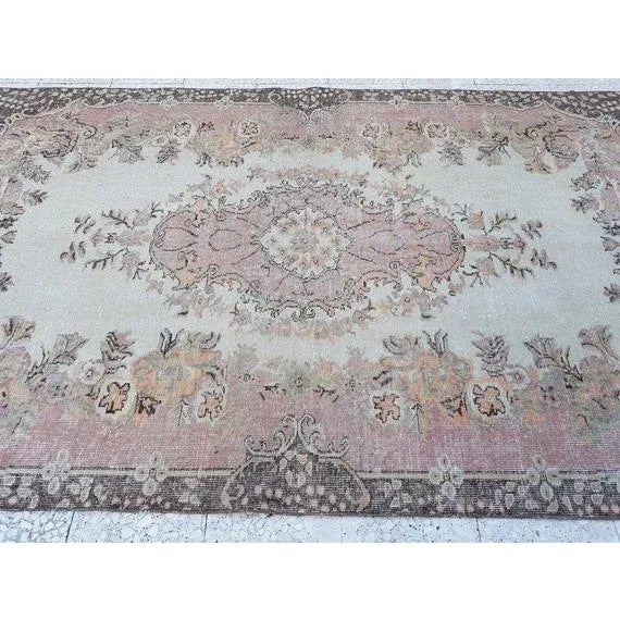 This is a vintage handwoven wool and cotton rug from Turkey. The piece was made in the 1970s.