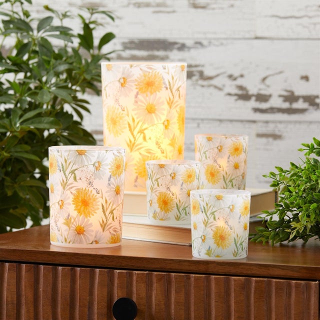 Add a vibrant touch of spring and summer to your home with the Floral Print Candle Holder Set. Featuring cheerful yellow...