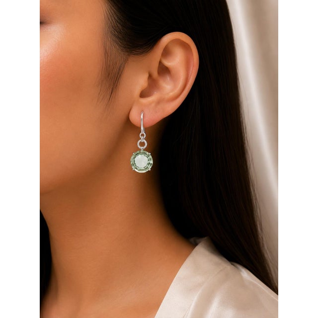 Elevate your style with these exquisite 18K white gold hanging earrings, featuring cabochon green amethysts paired with...