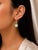 Elevate your style with these exquisite 18K white gold hanging earrings, featuring cabochon green amethysts paired with...