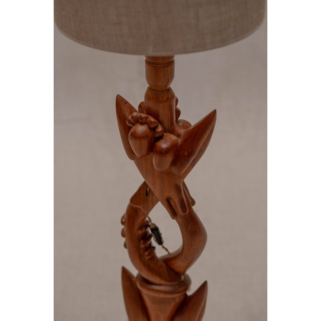 Elegant French mid century floor lamp dating from the 1960s, crafted from solid wood with a beautifully sculptural organic...