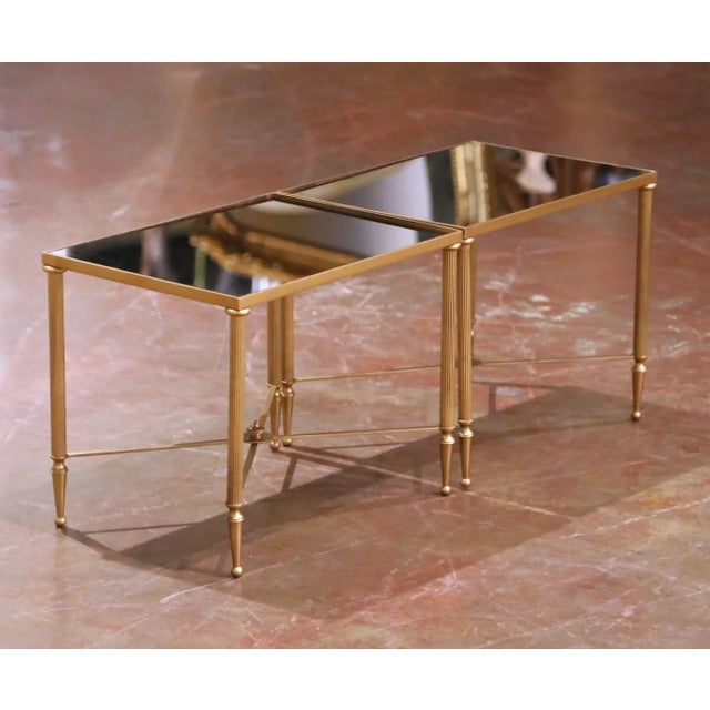 Designed in France circa 1960, this refined pair of mid-century side tables is executed in the manner of Maison Baguès,...