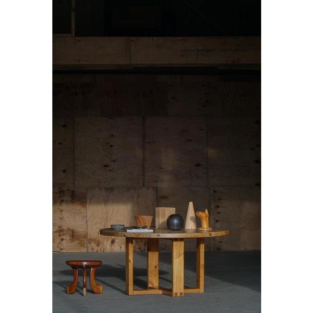 A beautiful Swedish dining table attributed to Roland Wilhelmsson, this round pine table exemplifies the restrained yet...