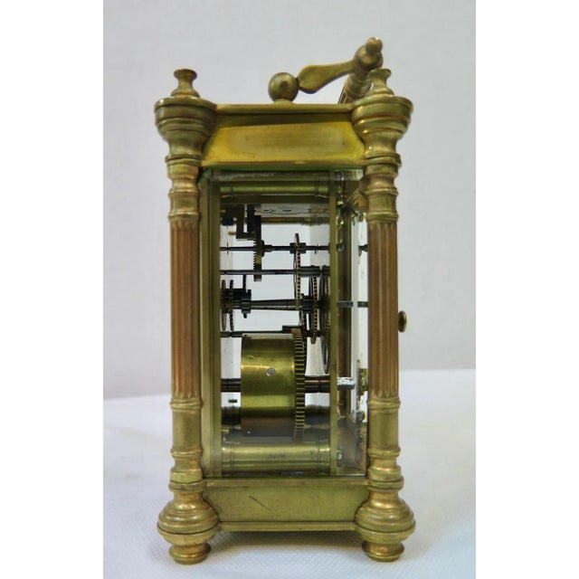 This vintage charming French brass & glass carriage clock dates from the 19th century. It features beveled glass panels...
