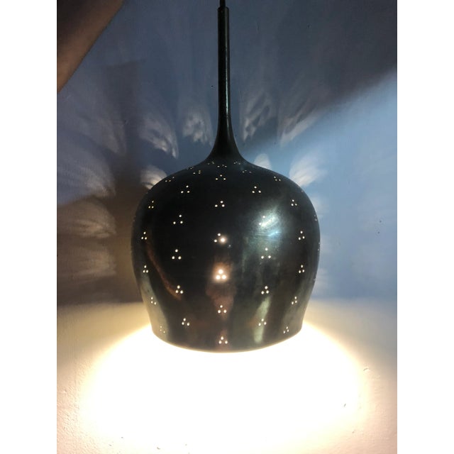 1950s Paavo Tynell counterweight pendant. This rare and exceptionally refined ceiling light is executed in brass, and can...