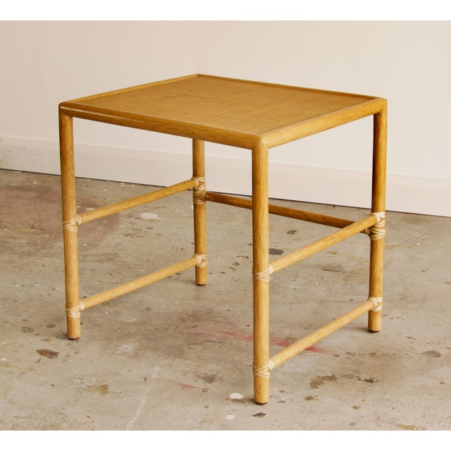 A clean-lined side table by McGuire of San Francisco, finished in the brand’s signature natural rattan tone. The frame has...