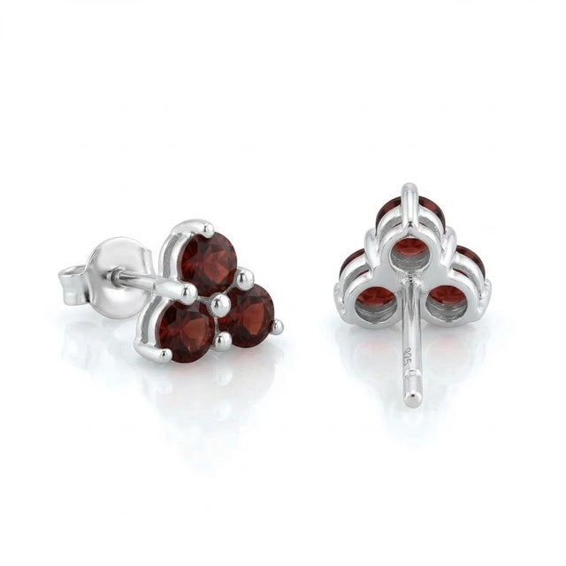 These elegant stud earrings feature a timeless cluster design, showcasing deep red Garnet gemstones known for their rich,...