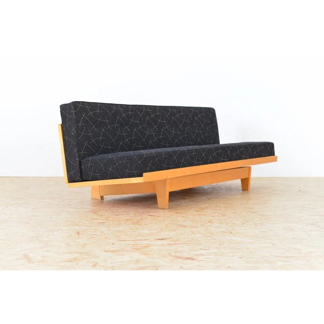 - Sofa bed from Aermo - Wood construction - Cover fabric is black with yellow pattern - When extended into a bed the...
