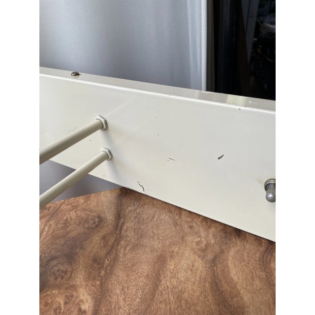 Post modern pair of off white enameled wall sconces with two fixed arms. No shades Included. These are outfitted with plug...