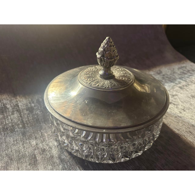 A beautiful unmarked antique crystal bowl with an acorn pull pewter top. Ornately decorated a could be from 19th century...