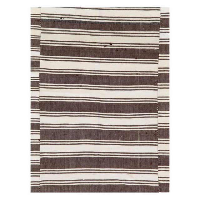 A vintage Turkish flat-weave Kilim accent rug handmade during the mid-20th century with an offset horizontally striped...