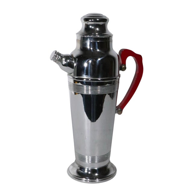 Art Deco chrome cocktail shaker with translucent red plastic handle. This example is in excellent, original, clean and...