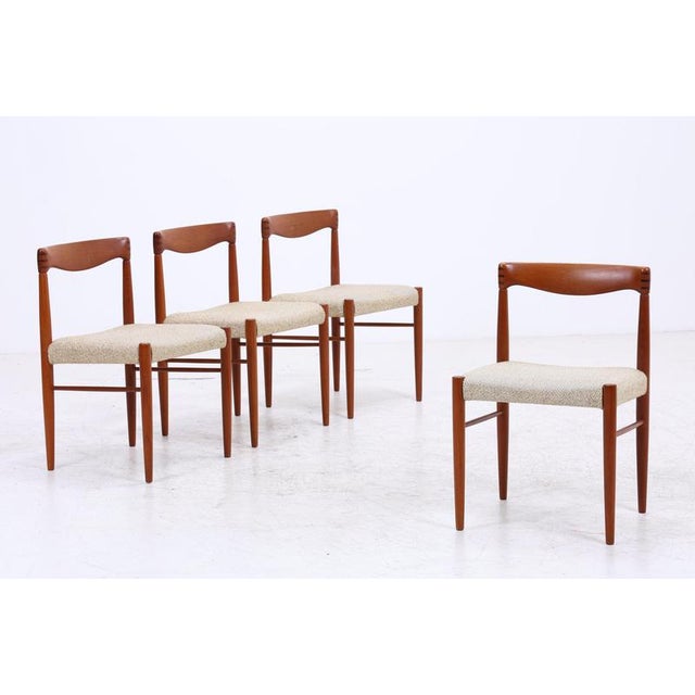 Set of four dining chairs by Henry W. Klein for Bramin, featuring warm teak wood and a finely shaped backrest. The dark...