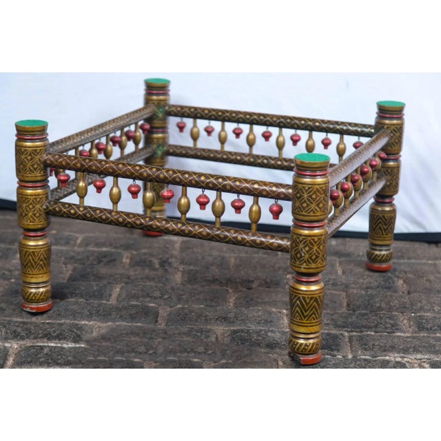 Fanciful Anglo-Indian style painted wood table base with red accents and carved wood "tassels".