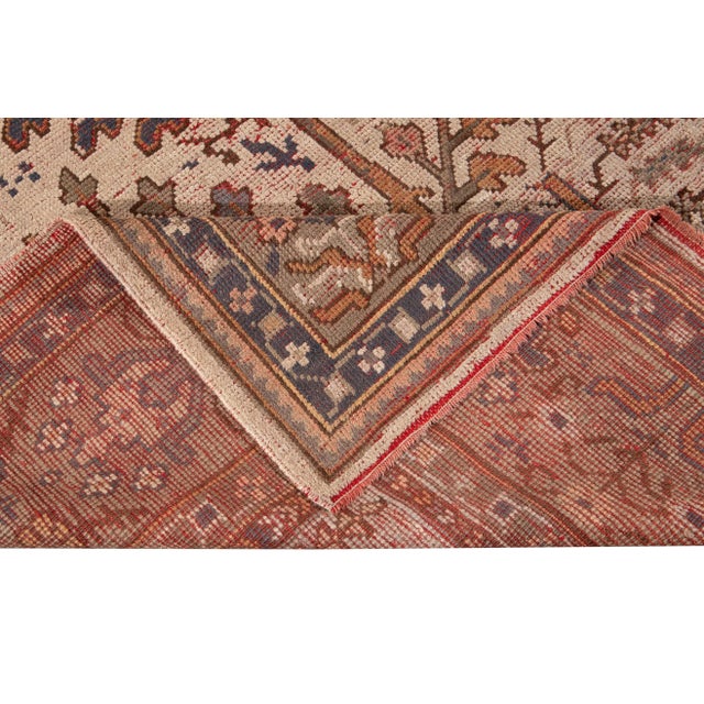 Beautiful Antique Turkish hand-knotted wool rug with a beige field. This rug has a designed gray frame with multicolor...