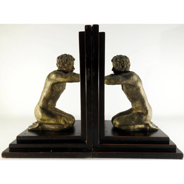 A pair of kneeling men are gazing in their respective mirrors in this pair of midcentury bookends. The nude men have...