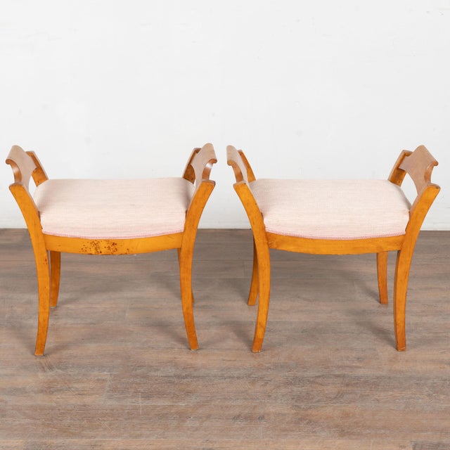 Classic lines define the silhouette this pair of Biedermeier stools. The aged patina of the yellow birch add the perfect...