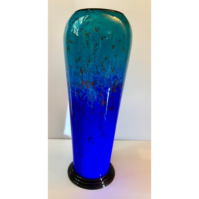 A tall statement vase measuring 16.5” in height. Cylindrical hand blown art glass vase featuring a rich gradient from deep...