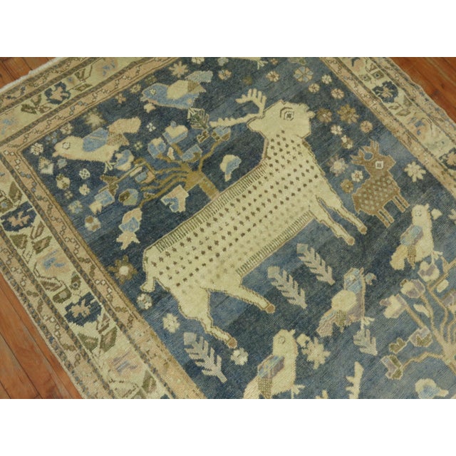 A highly decorative mid-20th century Turkish rug with 2 large sheep on a casual gray blue sea foam colored ground. Smaller...