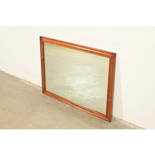 A gorgeous American Colonial style solid cherry wood framed wall mirror By L. & J. G. Stickley USA, 1957 Measures: 42"W x...