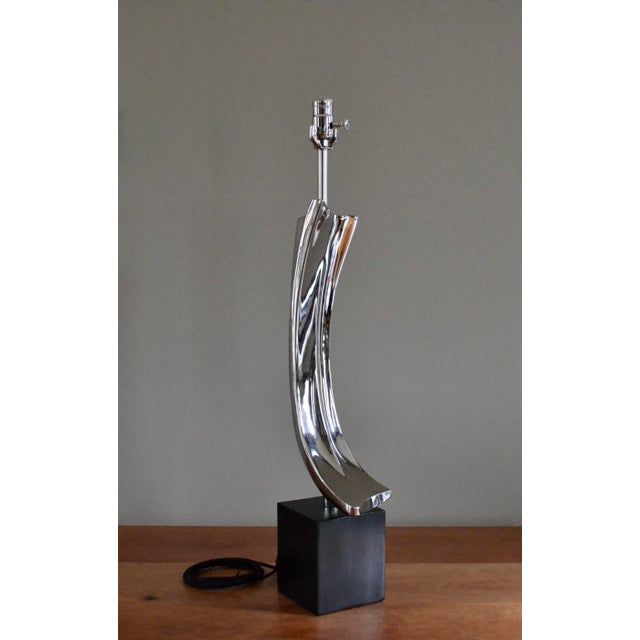 Mid century sculptural "Brush Stroke" lamp by Maurizio Tempestini for Laurel. Polished nickel on black enameled cube base....