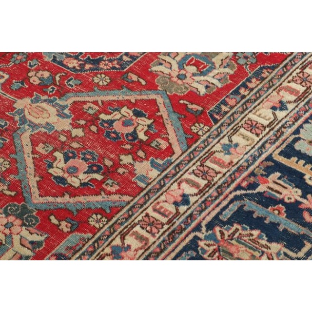 Made with hand-knotted wool and originating in the late 19th century, this 9x12 antique Persian rug of Heriz provenance is...