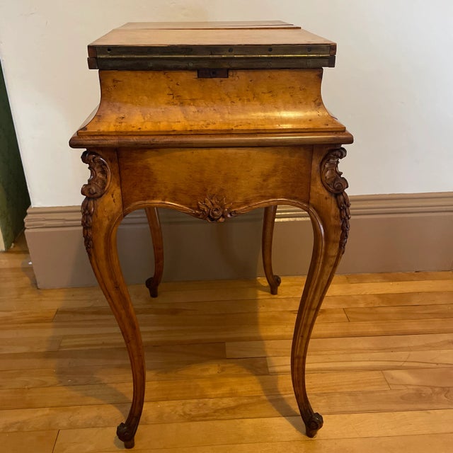 Gorgeous feminine lines on this carved leg Birds Eye Maple sewing table. The top folds out and it has two drawers. It came...