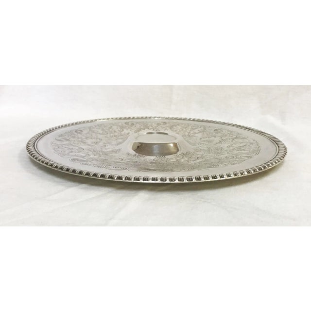 Perfect for entertaining! This round appetizer tray is made of silverplate, and has a raised center section for holding...