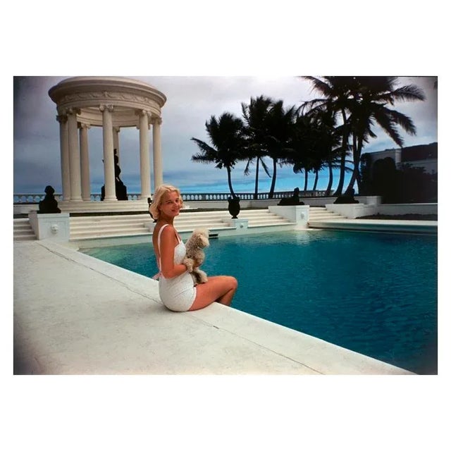 CZ by the Pool 1955 American socialite Mrs. Winston F. C. Guest (aka CZ Guest, 1920 – 2003) perches on the edge of the...