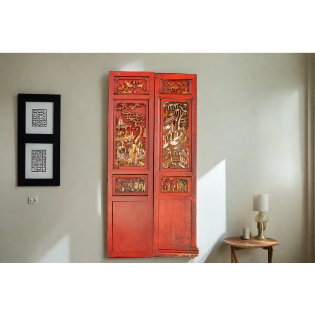 Wearing a beautiful red hue, this set of two old Chinese parcel-gilt and lacquered panels are each of a long rectangular...