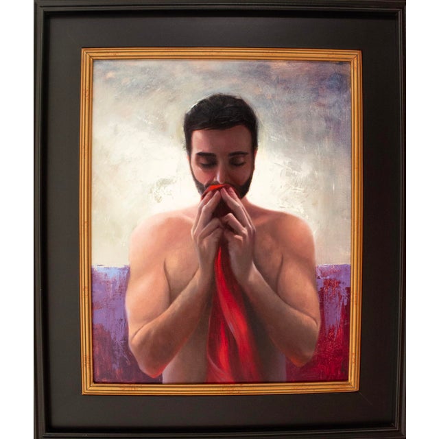 This oil on panel artwork portrays a contemplative figure, shirtless and holding a vibrant red cloth close to his face,...