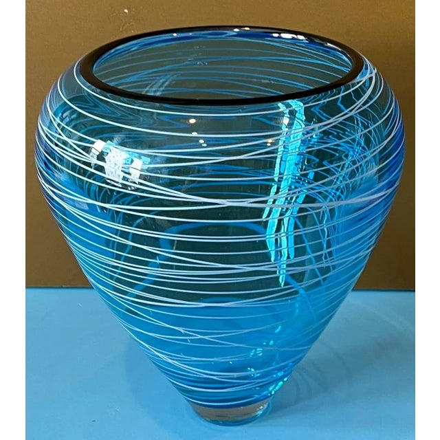 This beautiful Art Glass Vase was hand blown by renowned artisans in Seattle, Washington from blue glass. An applied...