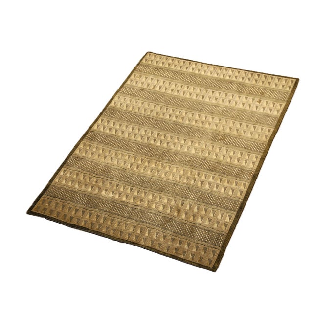 A refined composition of architectural precision and tactile softness, this 6'x9' hand-knotted rug from the Ariana Modern...