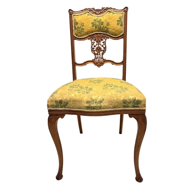 An elegant matching armchair and side chair, provisionally dating to circa 1890–1910, capturing the decorative richness of...