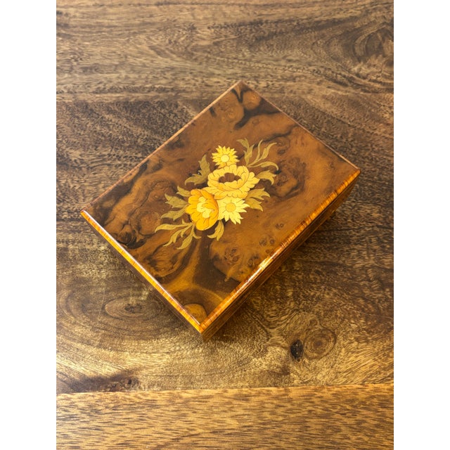Elegant mid century Italian music jewelry box featuring a warm medium brown burl wood veneer with a finely cut marquetry...
