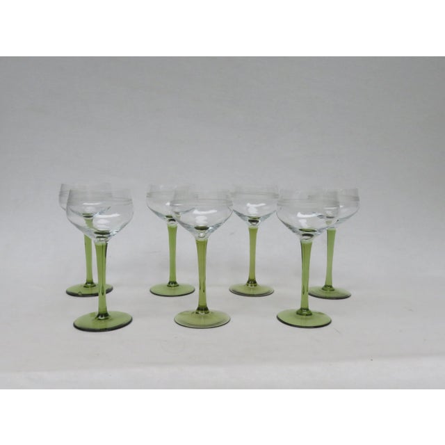 Elegant wine glasses from the Art Nouveau period. The stem and base are made of moss green glass, the bowl is made of...